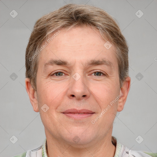 Joyful white adult male with short  brown hair and grey eyes