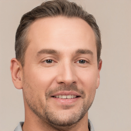 Joyful white young-adult male with short  brown hair and brown eyes