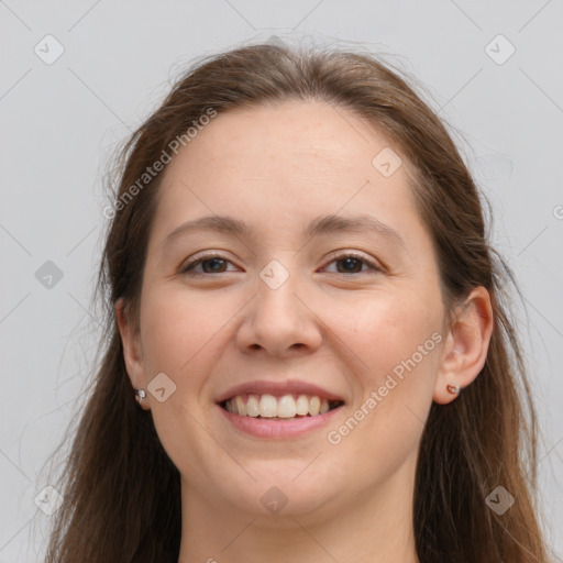 Joyful white young-adult female with long  brown hair and grey eyes