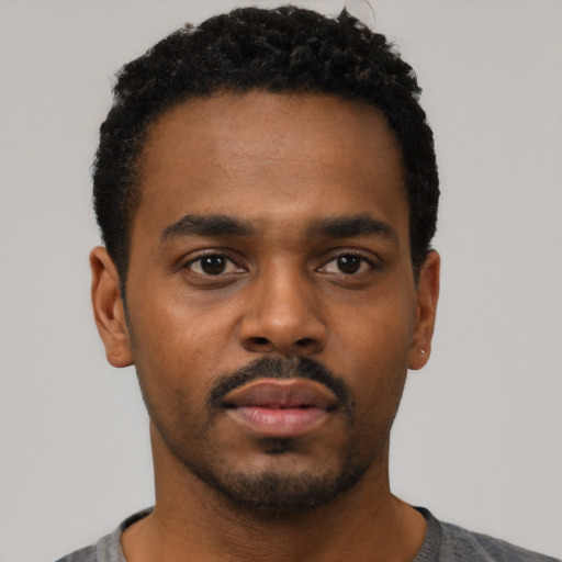 Neutral black young-adult male with short  black hair and brown eyes