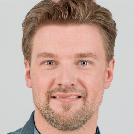 Joyful white young-adult male with short  brown hair and blue eyes