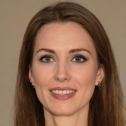 Joyful white young-adult female with long  brown hair and green eyes