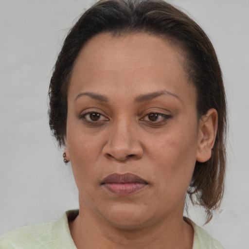 Joyful white adult female with medium  brown hair and brown eyes