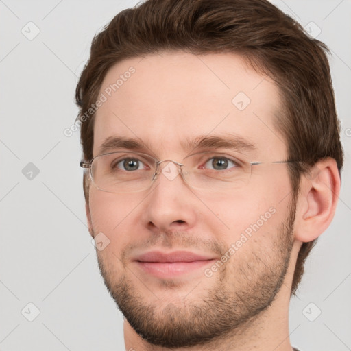 Joyful white young-adult male with short  brown hair and grey eyes