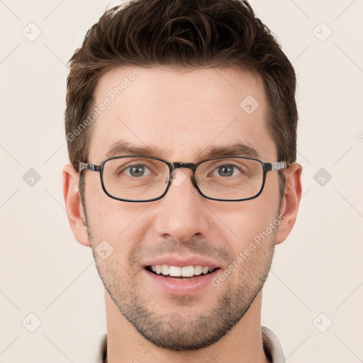 Joyful white young-adult male with short  brown hair and grey eyes