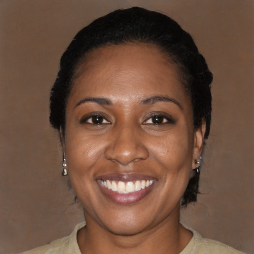 Joyful black adult female with medium  black hair and brown eyes