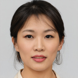 Joyful asian young-adult female with medium  brown hair and brown eyes