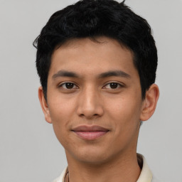 Joyful asian young-adult male with short  black hair and brown eyes