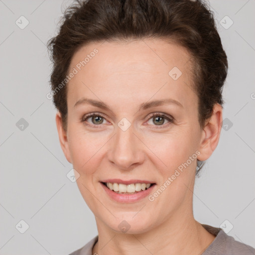 Joyful white adult female with short  brown hair and grey eyes