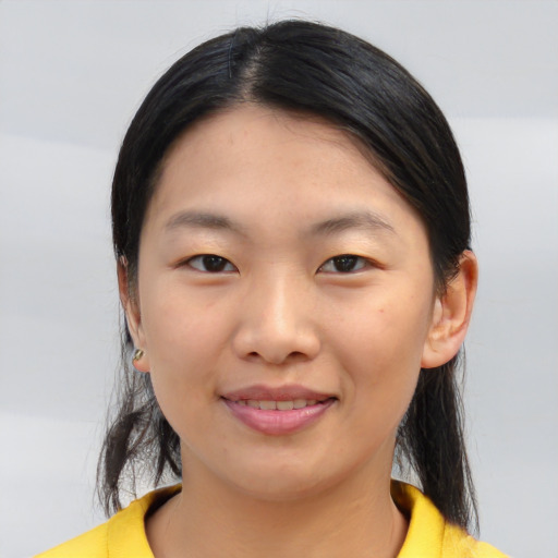 Joyful asian young-adult female with medium  black hair and brown eyes