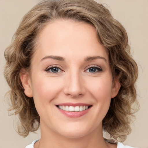 Joyful white young-adult female with medium  brown hair and green eyes