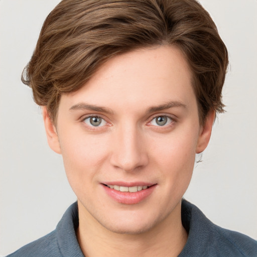 Joyful white young-adult female with short  brown hair and blue eyes