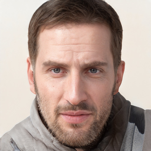 Joyful white adult male with short  brown hair and grey eyes