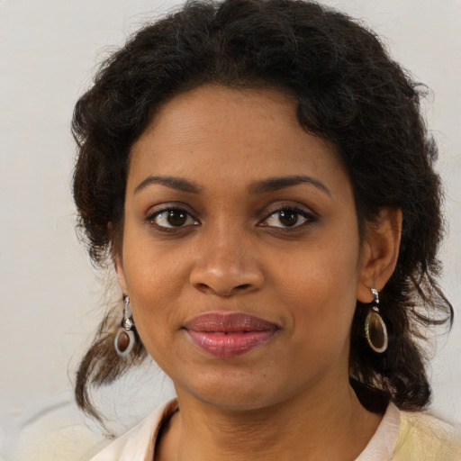 Joyful black young-adult female with medium  brown hair and brown eyes