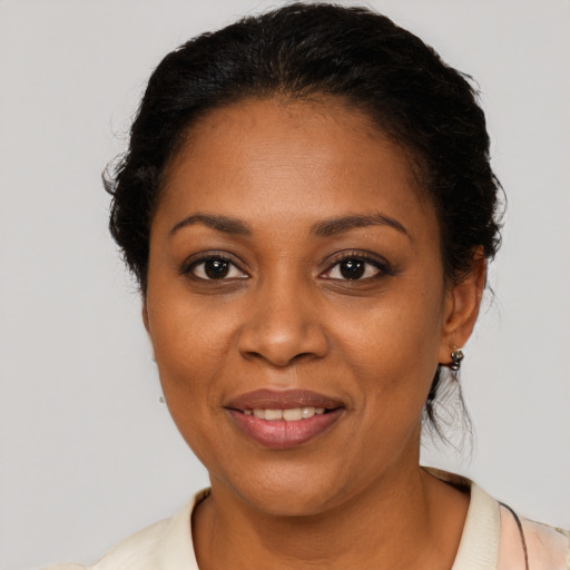 Joyful black adult female with short  brown hair and brown eyes