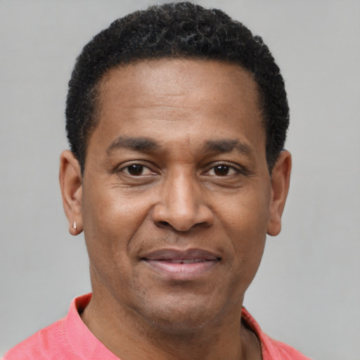 Joyful latino adult male with short  brown hair and brown eyes
