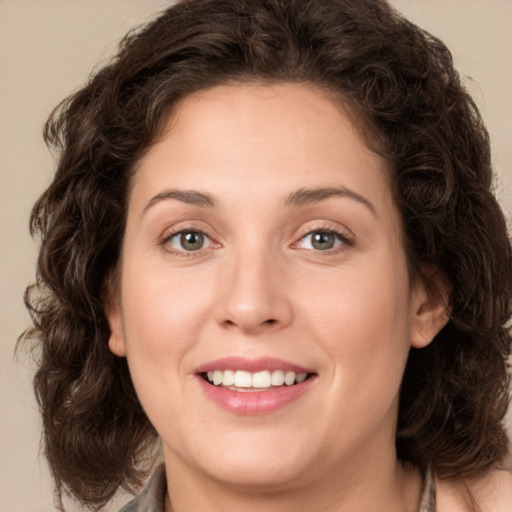 Joyful white young-adult female with medium  brown hair and green eyes