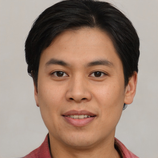 Joyful asian young-adult male with short  brown hair and brown eyes