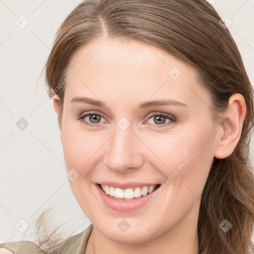 Joyful white young-adult female with long  brown hair and blue eyes