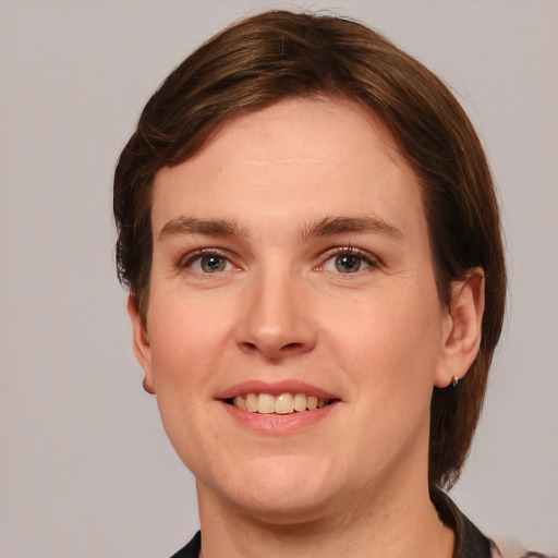 Joyful white young-adult female with medium  brown hair and grey eyes