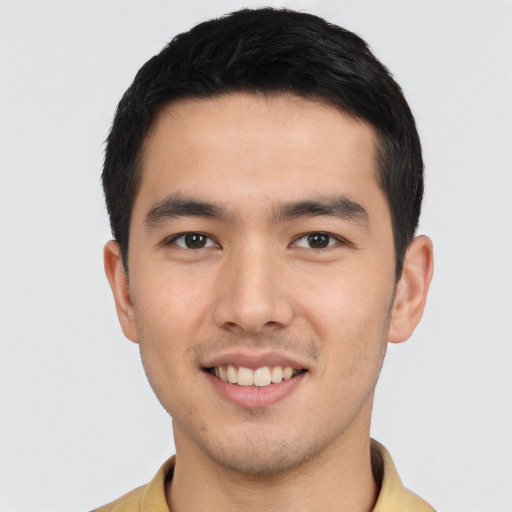 Joyful asian young-adult male with short  black hair and brown eyes