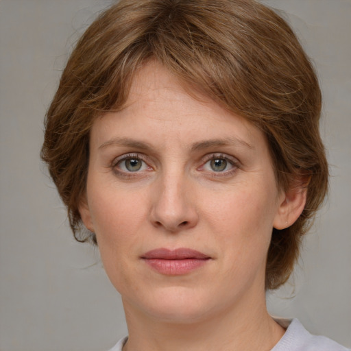 Joyful white young-adult female with medium  brown hair and green eyes