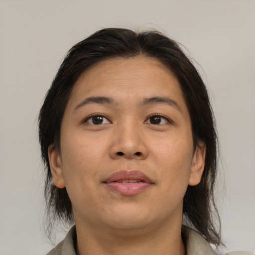 Joyful asian adult female with medium  brown hair and brown eyes