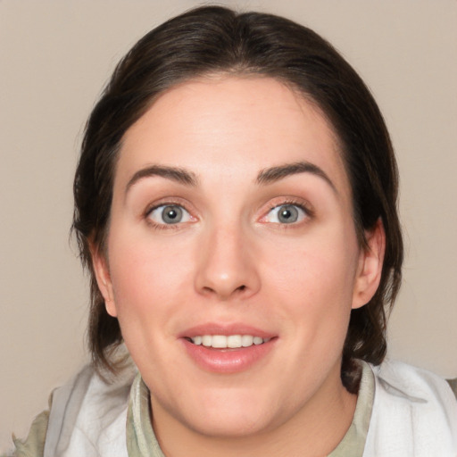 Joyful white young-adult female with medium  brown hair and blue eyes