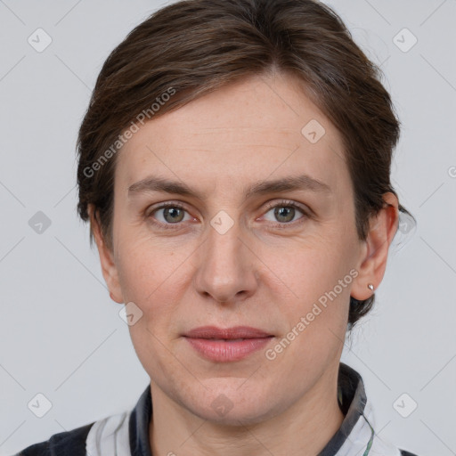 Joyful white adult female with short  brown hair and grey eyes