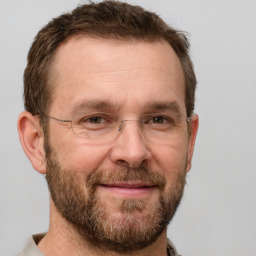 Joyful white adult male with short  brown hair and grey eyes