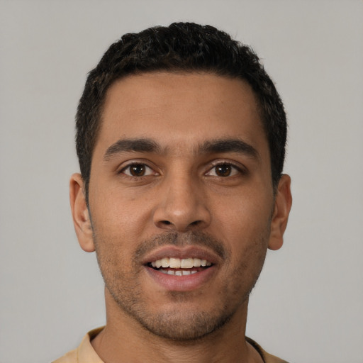 Joyful latino young-adult male with short  black hair and brown eyes