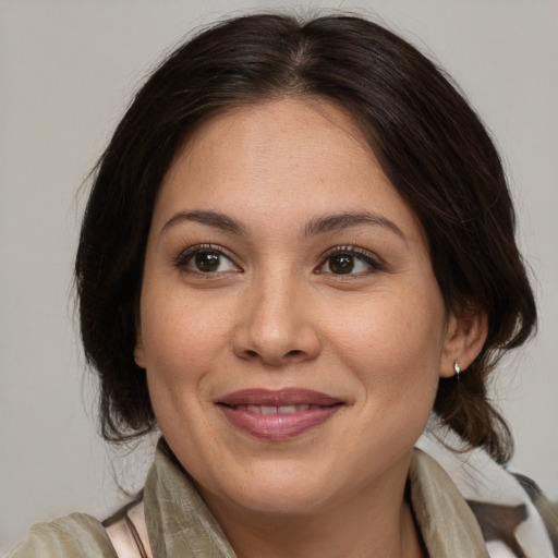 Joyful latino young-adult female with medium  brown hair and brown eyes