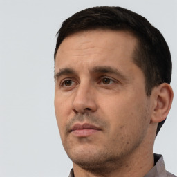 Neutral white adult male with short  black hair and brown eyes