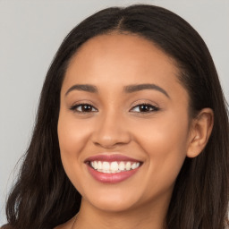 Joyful latino young-adult female with long  brown hair and brown eyes