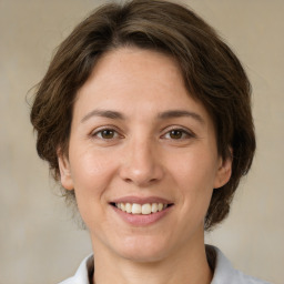 Joyful white young-adult female with medium  brown hair and brown eyes