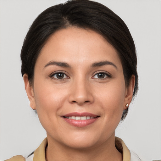 Joyful white young-adult female with medium  brown hair and brown eyes