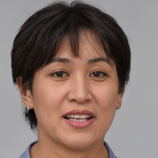 Joyful white adult female with medium  brown hair and brown eyes