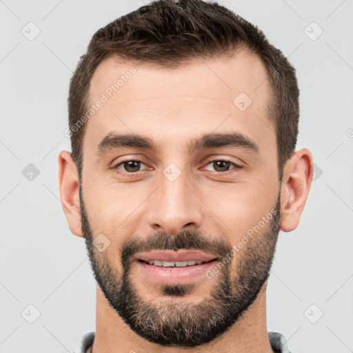 Joyful white young-adult male with short  brown hair and brown eyes