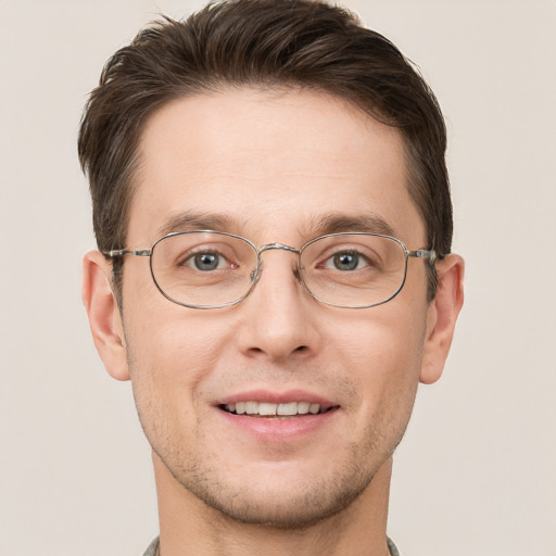 Joyful white adult male with short  brown hair and grey eyes