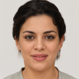 Joyful latino young-adult female with medium  brown hair and brown eyes