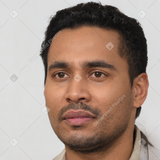 Neutral latino young-adult male with short  black hair and brown eyes