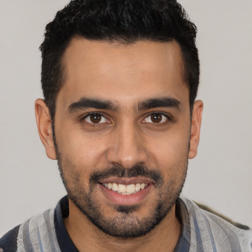 Joyful white young-adult male with short  black hair and brown eyes