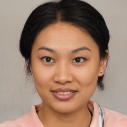 Joyful asian young-adult female with medium  brown hair and brown eyes