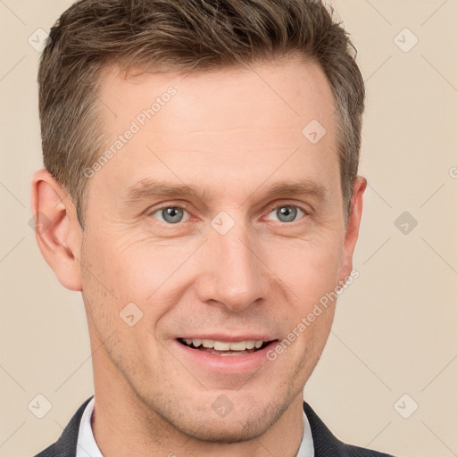 Joyful white adult male with short  brown hair and grey eyes