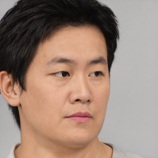 Neutral asian young-adult male with short  brown hair and brown eyes
