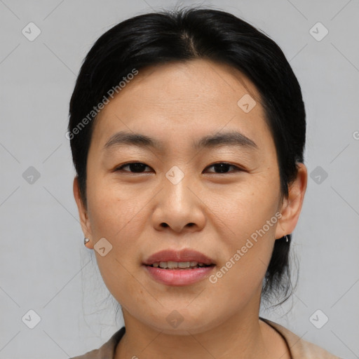 Joyful asian young-adult female with medium  black hair and brown eyes