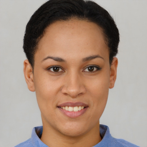 Joyful black young-adult female with short  brown hair and brown eyes