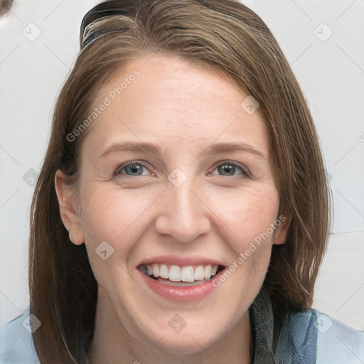 Joyful white adult female with long  brown hair and grey eyes