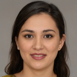 Joyful white young-adult female with long  brown hair and brown eyes