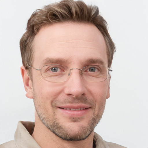 Joyful white adult male with short  brown hair and grey eyes